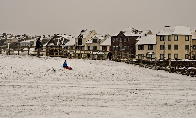 Photo of a child sledging near Maryport harbour