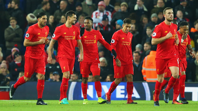 Liverpool players celebrate premier league win at stoke city