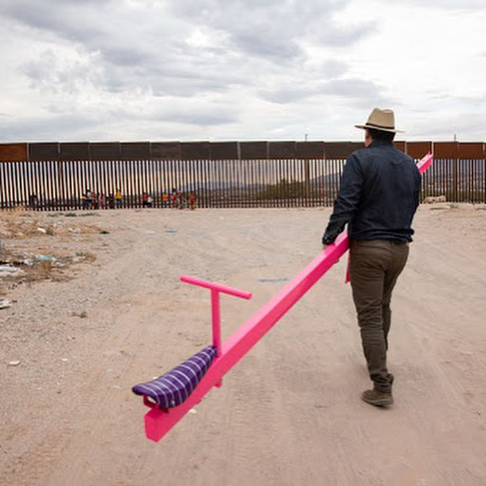 US And Mexico Kids Play Together On Seesaws Built On The Border Wall In Defiance Of Donald Trump