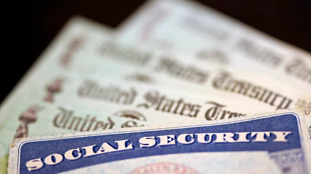 A Social Security card sits alongside checks from the U.S. Treasury on Oct. 14, 2021, in Washington, D.C. (Kevin Dietsch / Getty Images / Getty Images)