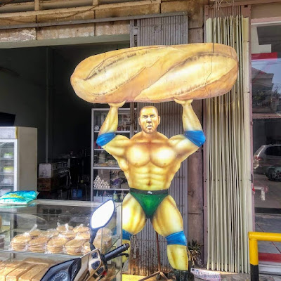 cutout strongman advertisement bread shop or bakery in battambang cambodia