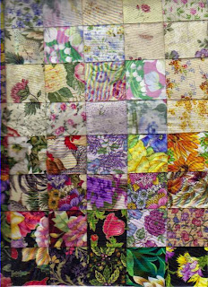 Watercolor quilt with flower patterns in light to dark hues