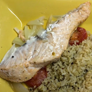 Salmon with tomatoes and onions served