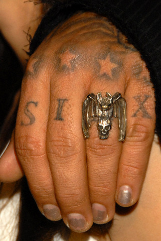 Four stars tattoo above each fingers on the tattooed hand