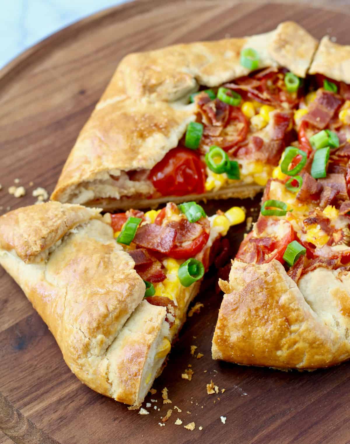 Bacon, Tomato, and Corn Galette with a slice cut out.