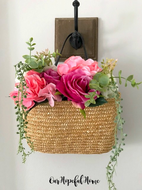 pretty purse filled with flowers hanging on door magnet hook with burlap bow