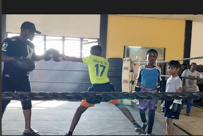 Kids in a boxing ring in Ghana learning to box