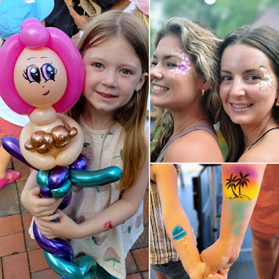 child with balloon mermaid sculpture, young women with flower face paint, and airbrush tattoos on a mom and daughter