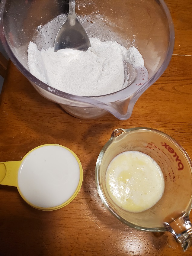 flour, melted butter and milk some of the ingredients for a triple berry cobbler