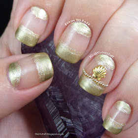 Gold french tip and half moon nail art with 3D microbead and shell stud accents.