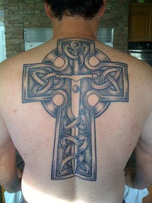 Cross with sword on back tattoo