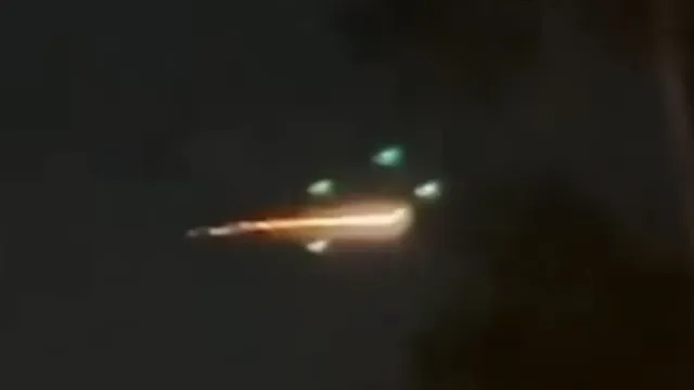 UFOs surrounding an inner UFO with flames coming from it over Raleigh NC USA.