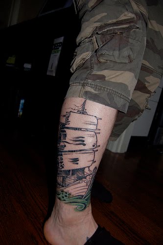 Ghost ship tattoo on leg.