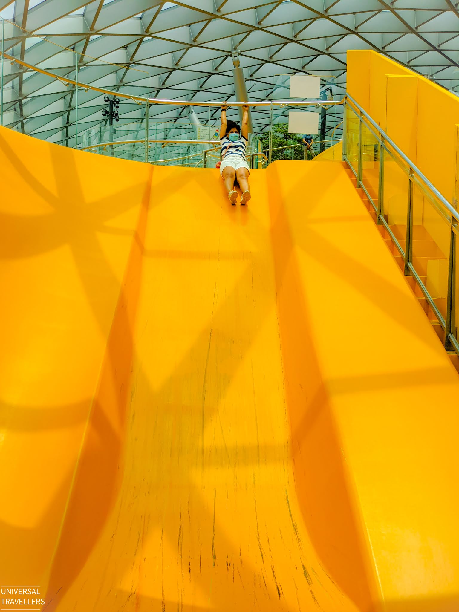 A girl is sliding through one of the Discovery Slides, located at level 5 inside the Jewel Changi Airport