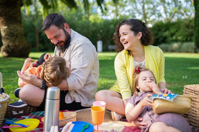 Family having a picnic in the park which is just one of the many family activities in Garden Grove, CA.