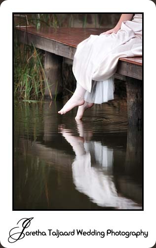 Bride dipping toes in water