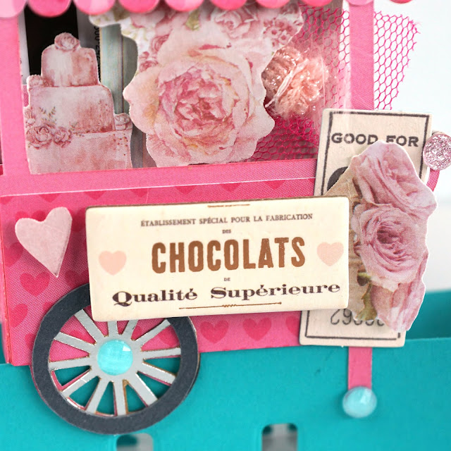 Heidi Swapp Memorydex Valentines Advent Calendar made with the Prima With Love collection by Frank Garcia; die cut 3D sweets cart decorated with ribbon, tulle, paper flowers, stickers, jewels and charms, and has a gift card holder