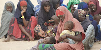 Refugees wait to be registered at a camp in Kenya after fleeing a food crisis in Somalia. (Image Credit: Andy Hall/Oxfam East Africa via Wikimedia Commons) Click to Enlarge.
