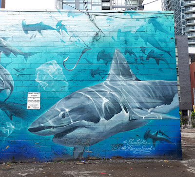 Portion of a full wall mural featuring a variety of different types of sharks - focus is a great white