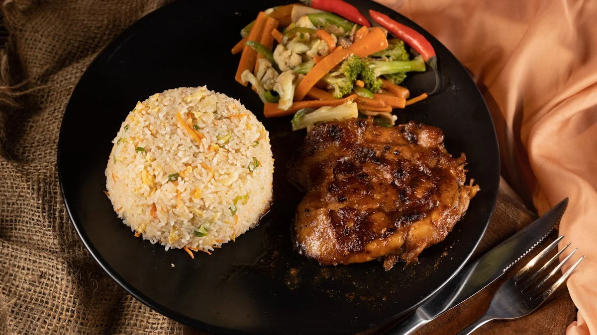 Rice and Meat with Vegetable Meal in a Black Plate Near a Fork and Knife