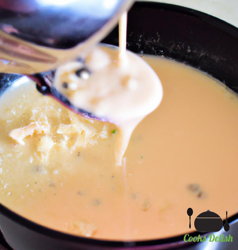Image of chicken broth and heavy cream being poured into the skillet. 