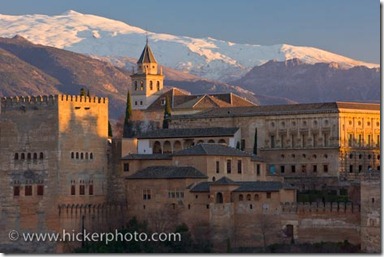 The Alhambra (La Alhambra) a moorish citadel and palace (designated a UNESCO World Heritage Site in 1984), backdropped by the snowcapped Sierra Nevada mountain range seen from Mirador de San Nicolas in the Albayzin district at sunset, City of Granada, Province of Granada, Andalusia (Andalucia), Spain, Europe.