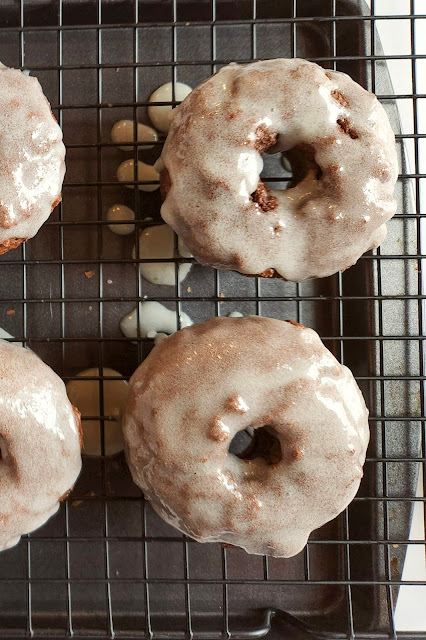 donuts lined up on a wire baking rack.