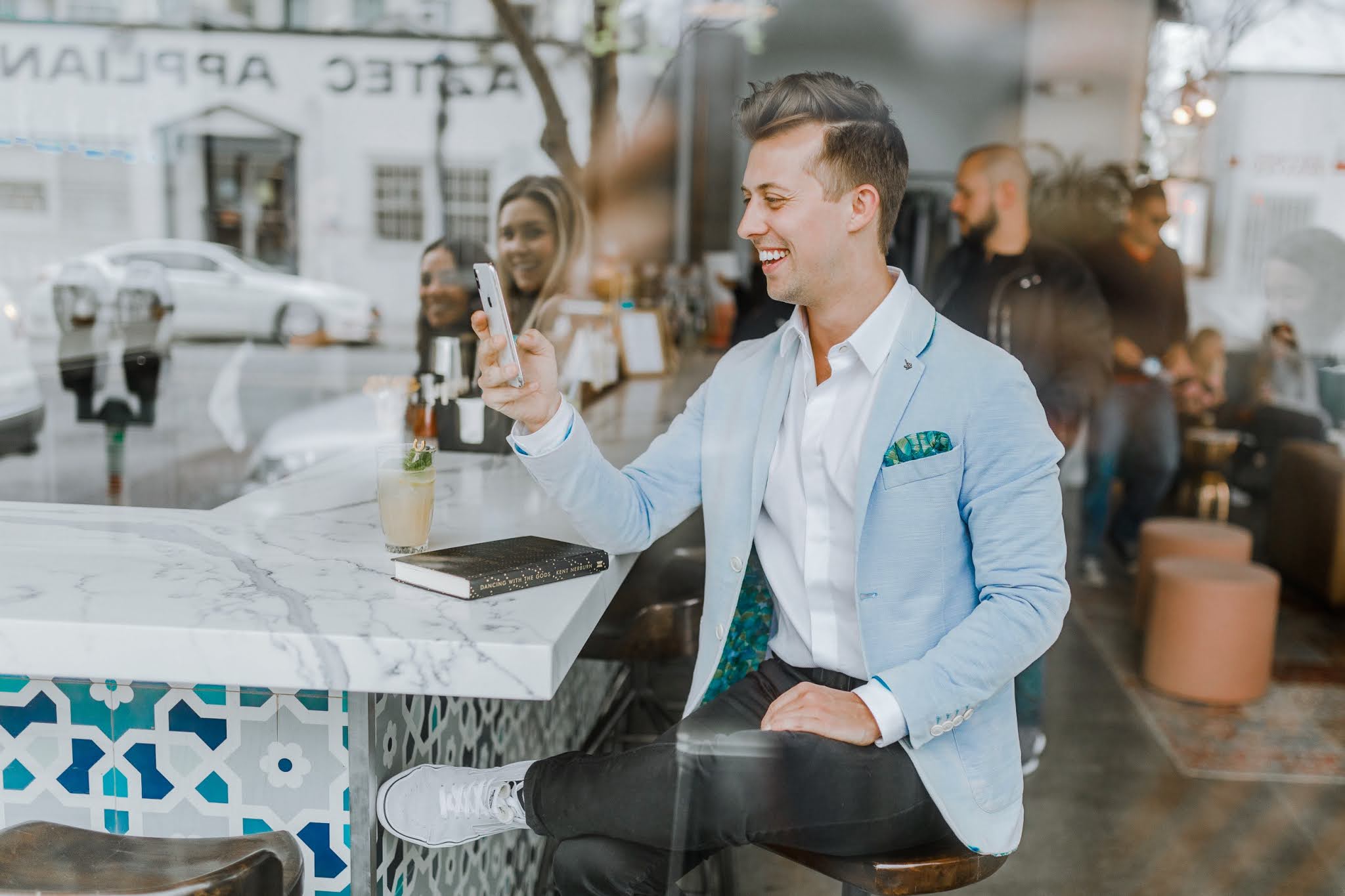 A guy at a restaurant checking his phone