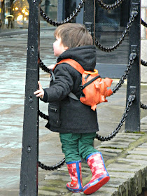 Bud exploring small boy toddler Liverpool Albert Dock wellies