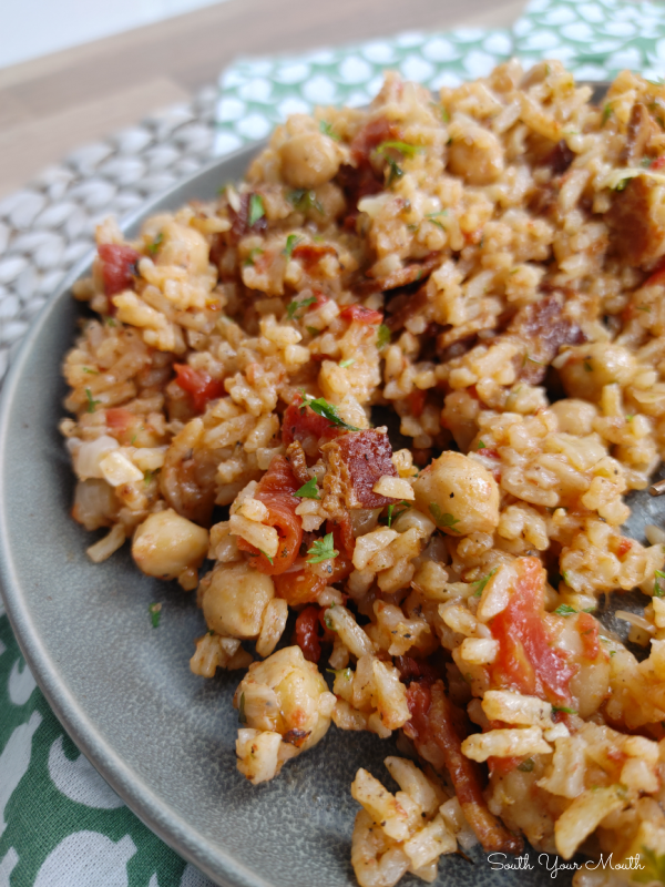 Mediterranean Chickpea Rice - A hearty rice recipe with chickpeas (garbanzo beans) flavored with bacon, tomatoes, onion and garlic perfect served on the side or as a main dish that easily converts to a meatless meal.