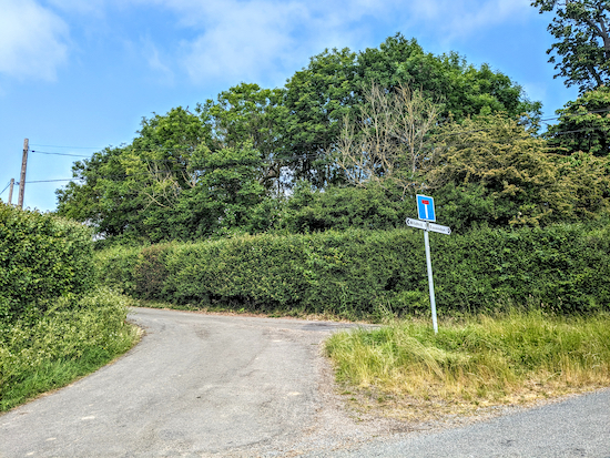 Head W along the lane  until you reach the last cottage on the right