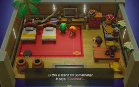 screenshot of Marin and Tarin's house from the beginning of the game, there is a stand that says Goomba