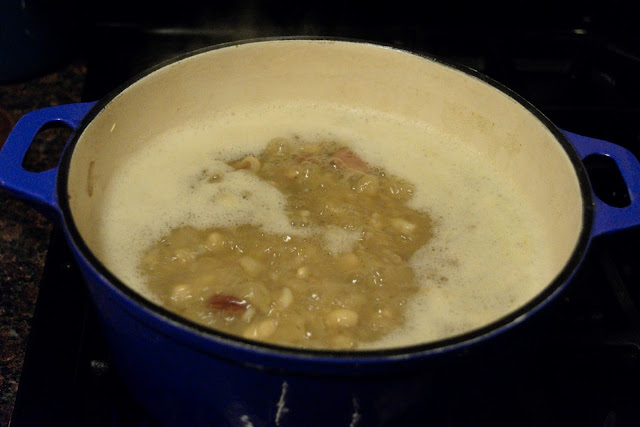 The soup simmering on stove top.