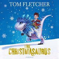 The Christmasaurus audiobook review. A small boy in a colourful dressing gown rides a snow-white and blue dinosaur across a snowy, nighttime landscape.