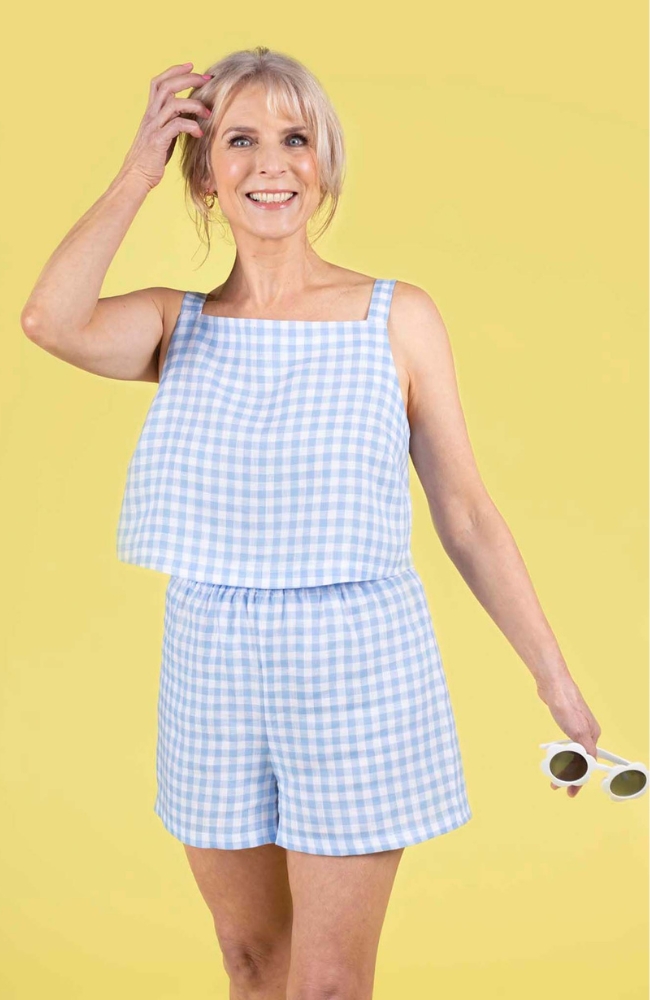 Model wearing a summery blue gingham shorts and top, made using the Esti co-ord sewing pattern