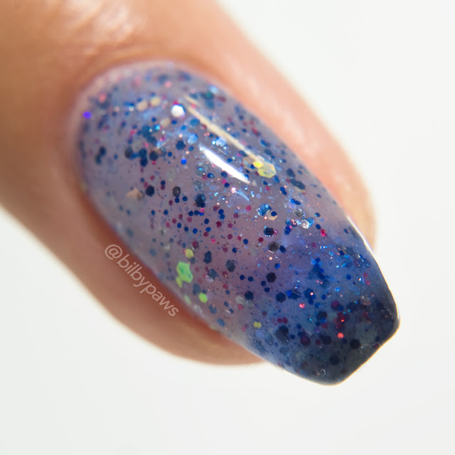 Macro of 'Halloween Raids in Hoenn' by MckFresh Nail Attire / Polish Pickup June 2018. A close up of a nail with a 3-colour jelly polish base with multi-coloured and iridescent glitters.