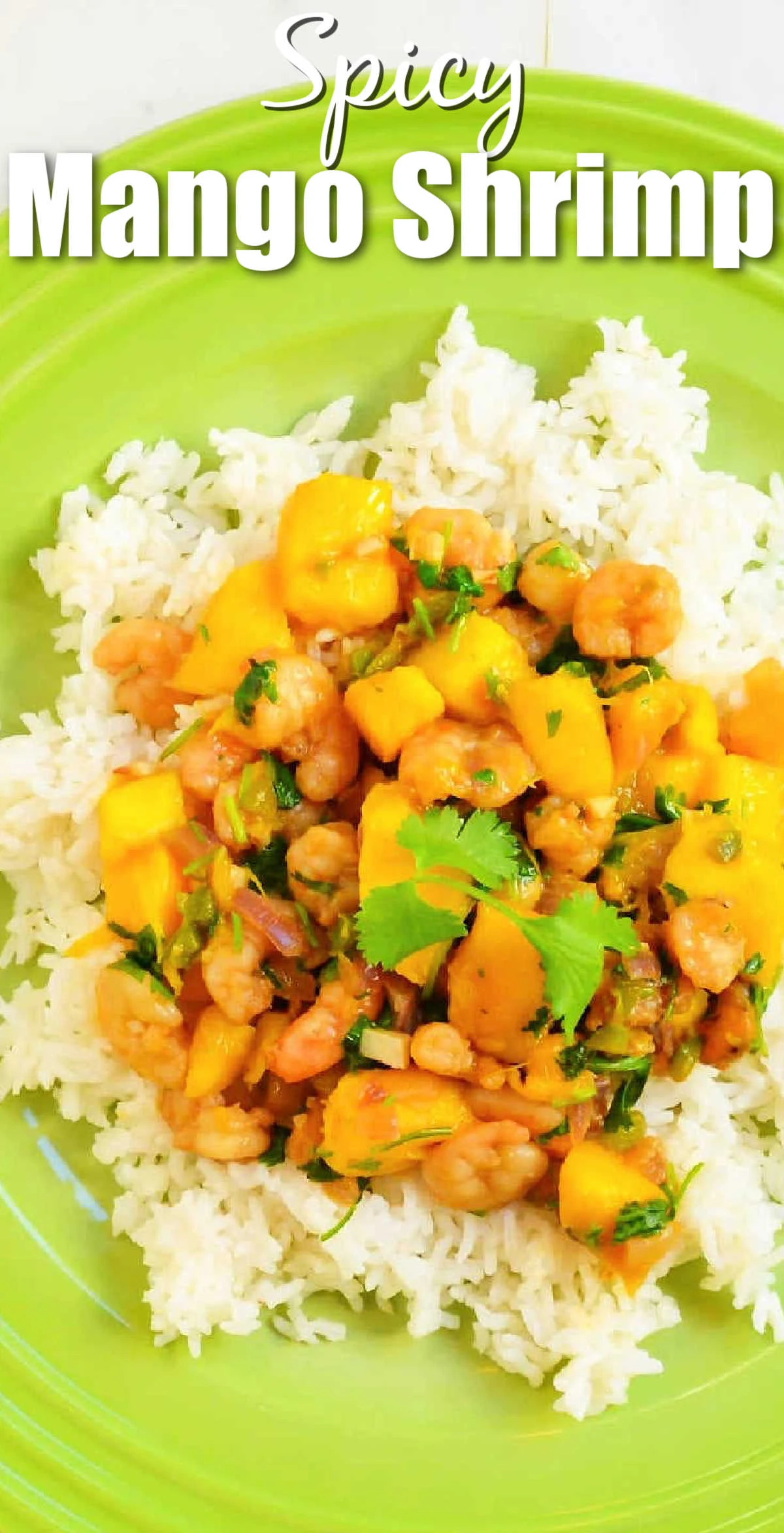A down shot of Spicy Mango Shrimp on a bed of rice on a green plate. White text at the top of photo Spicy Mango Shrimp.