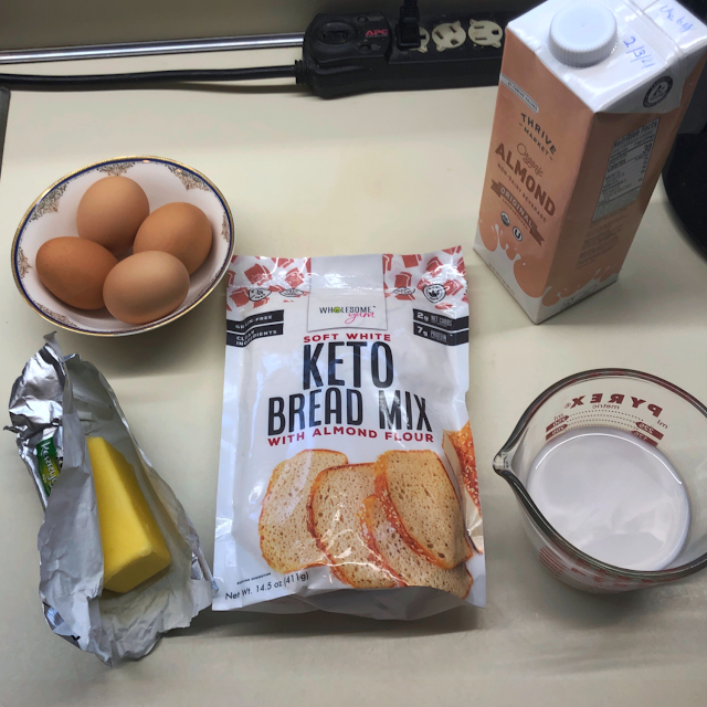 Ingredients to make Wholesome Yum Easy Keto Bread Mix: bag of mix, 6 tablespoons of butter, 4 eggs, and 3/4 cup almond milk