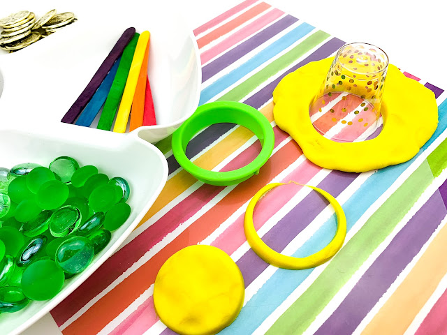 play dough and cookie cutters on a striped background.