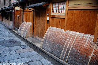 Arched bamboos close to the wooden outer wall, Gion, Kyoto