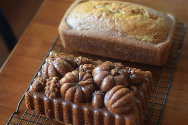 The loaves of pumpkin bread, removed from the pan, on a cooling rack. 