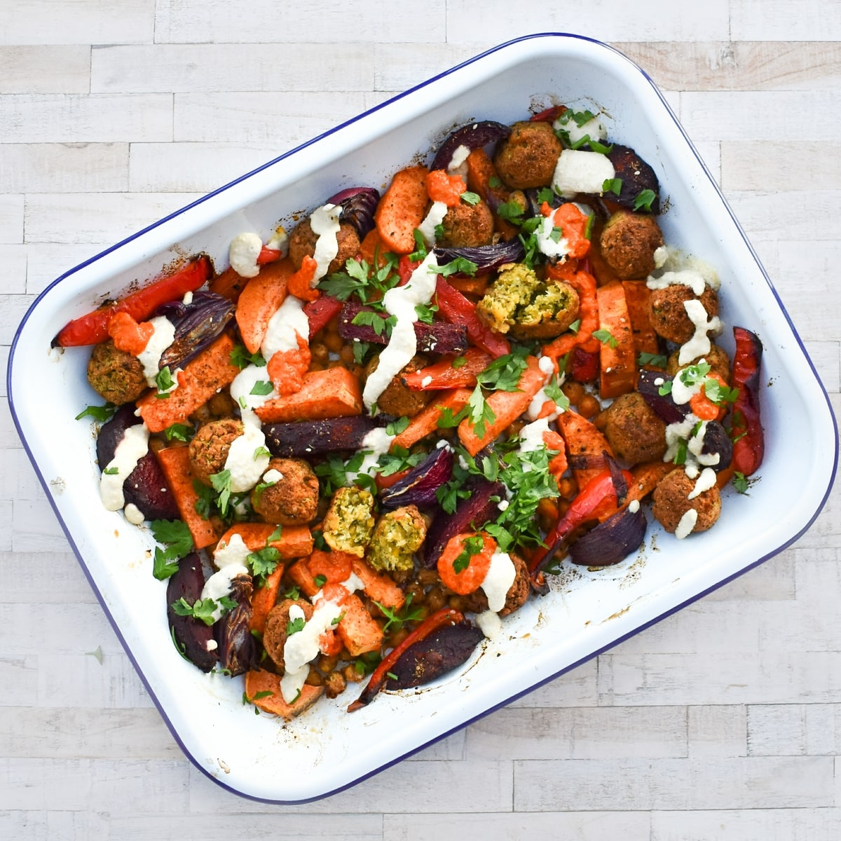 Sweet potato bake topped with hummus, red pepper paste & fresh herbs.