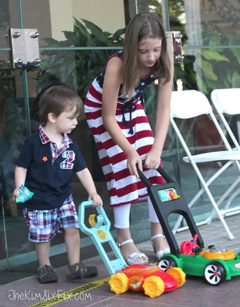 Kids with toy lawnmowers