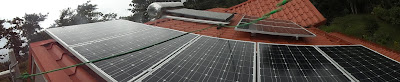 8 roof-mounted PV panels + solar hot water heater