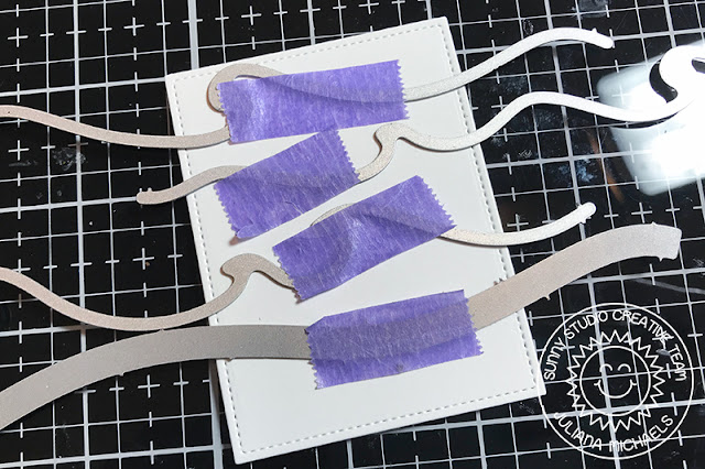 Inlaid die cutting background using Sunny Studio Stamps Catch A Wave Dies and Woodland Border Dies. Use Therm O Web Purple Tape to hold the dies in place.