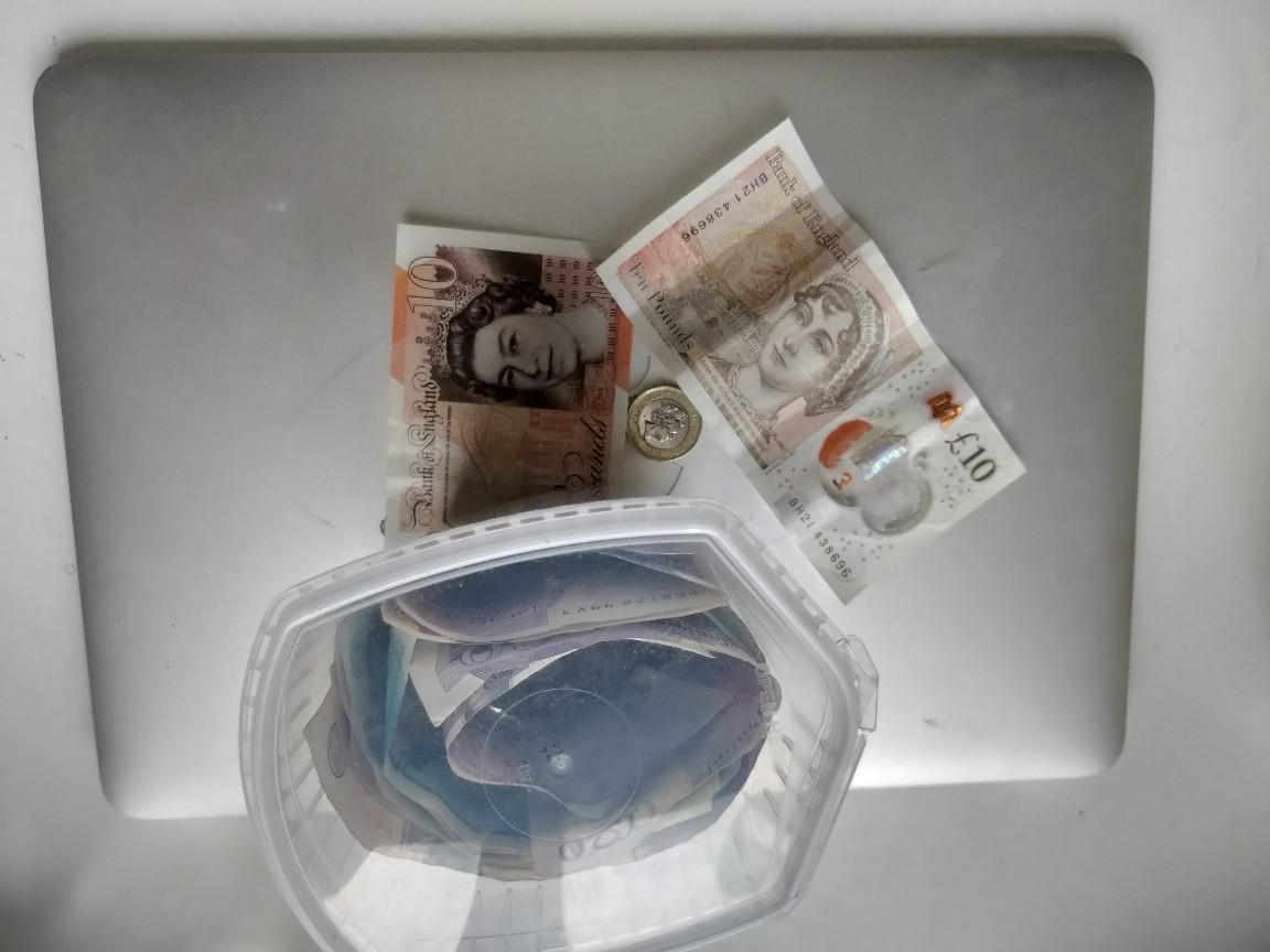 twenty one pounds sterling next to the money pot