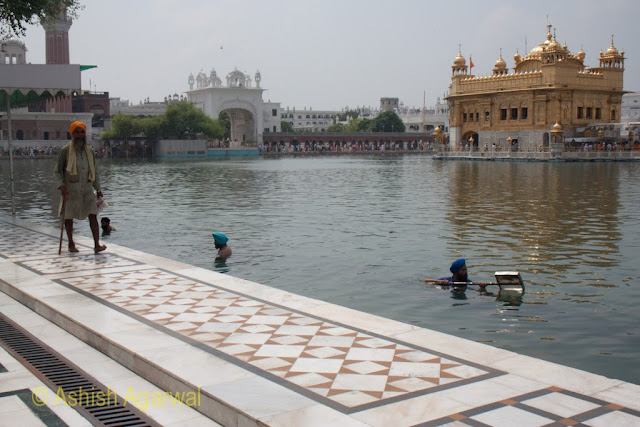 Volunteers cleaning the tank of the Golden Temple in Amritsar