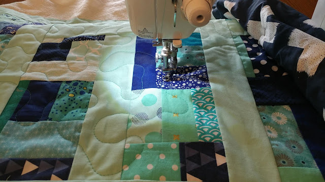 Detour quilt in aqua and navy from Stash Statement quilting book by Kelly Young