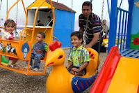 A father pushes his son on a swing at the Oct. 28 grand opening of Dover Park in the Qahira neighborhood of Baghdad’s Adhamiyah district. (U.S. Army photo by Sgt. Jerry Saslav, 3rd BCT PAO, 4th INF. DIV.)