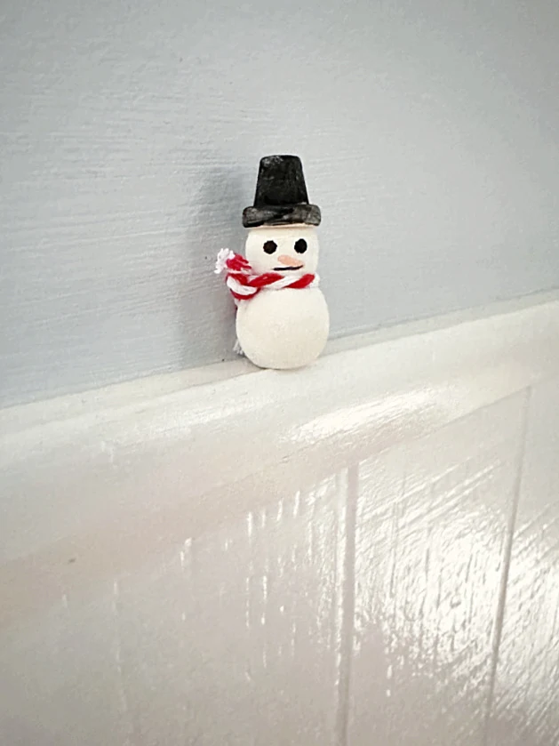 snowman on wall ledge